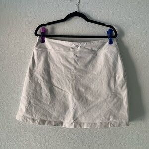 Athleta White Mini Skirt with Subtle Sunburst Logo